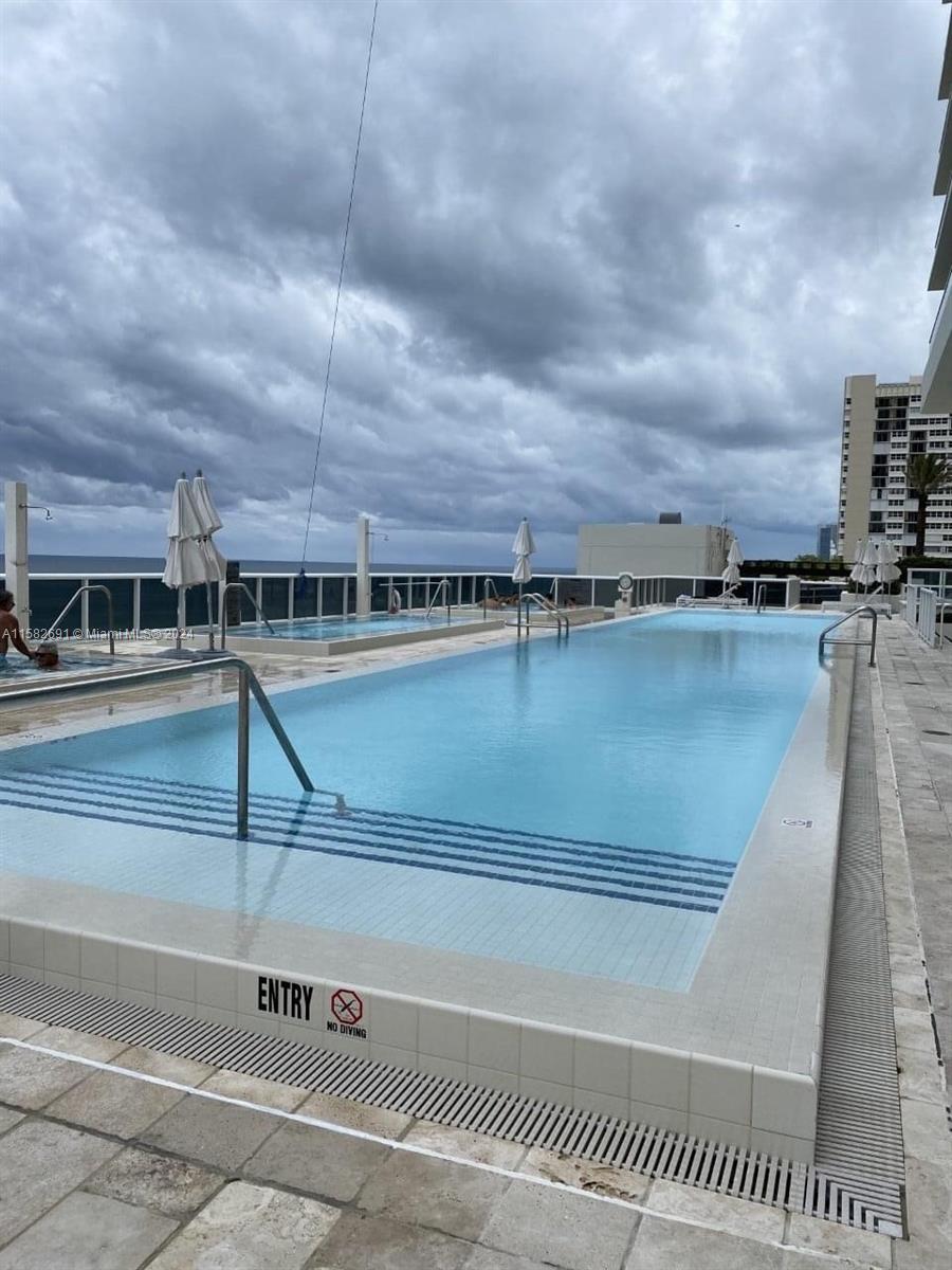 a view of a swimming pool with a lake view