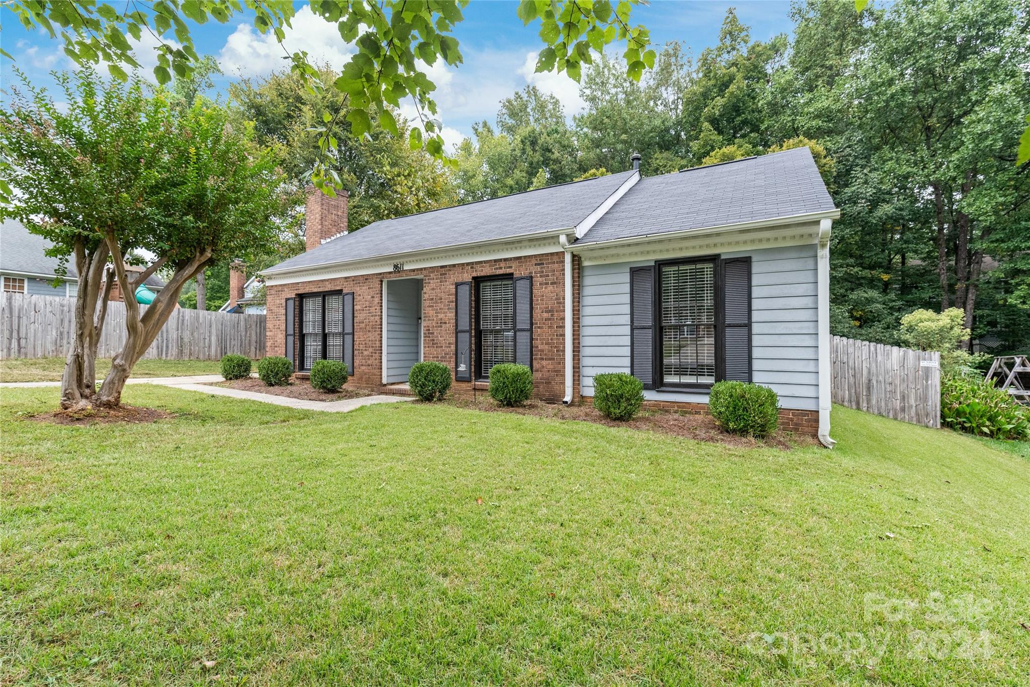 a view of a house with backyard and porch