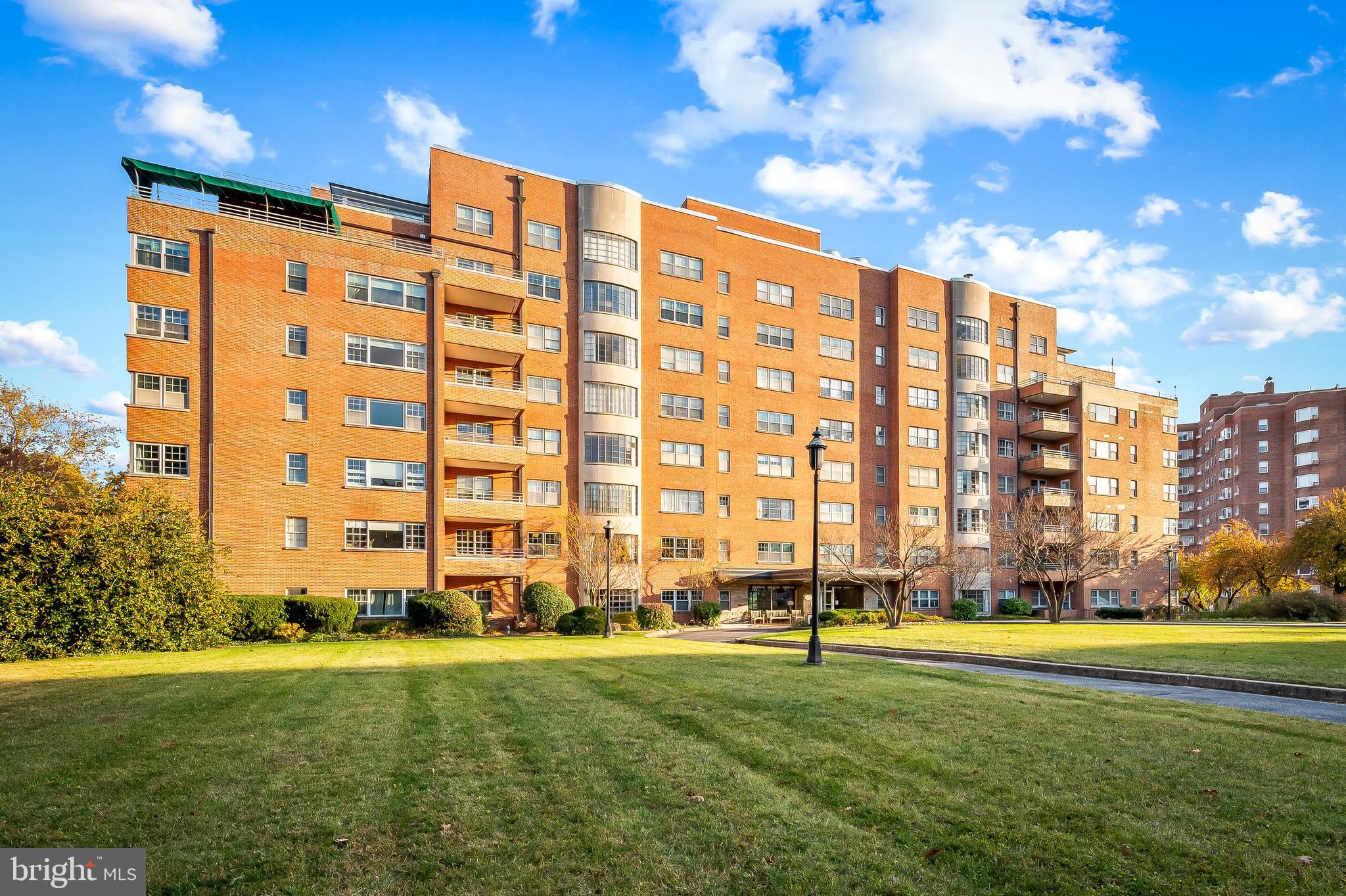 a view of a big building with a big yard and plants