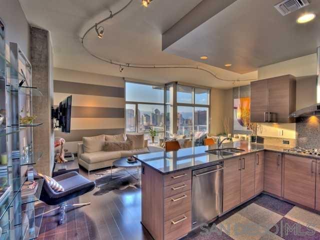 a kitchen with sink refrigerator and cabinets