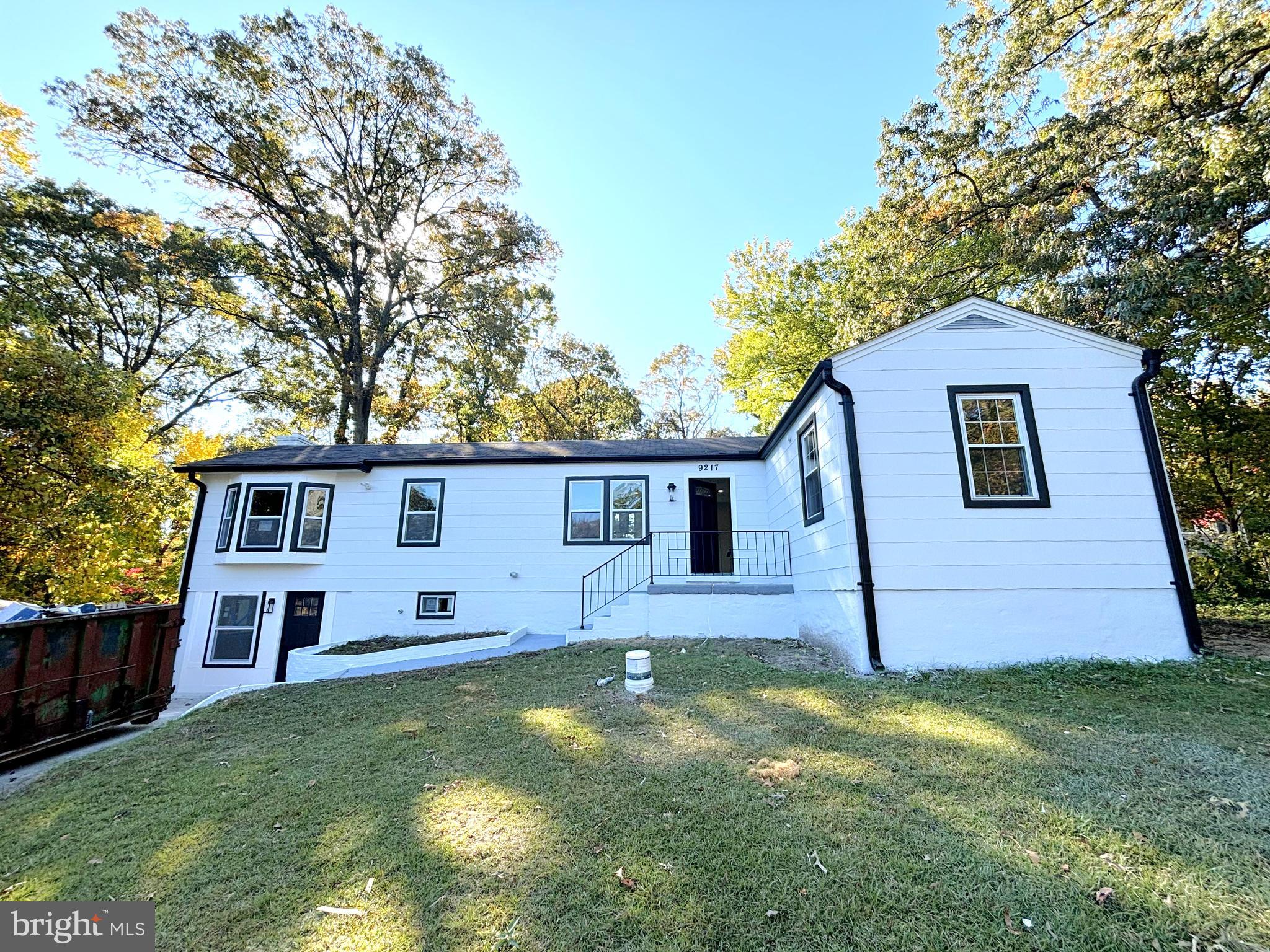 a front view of house with yard and trees