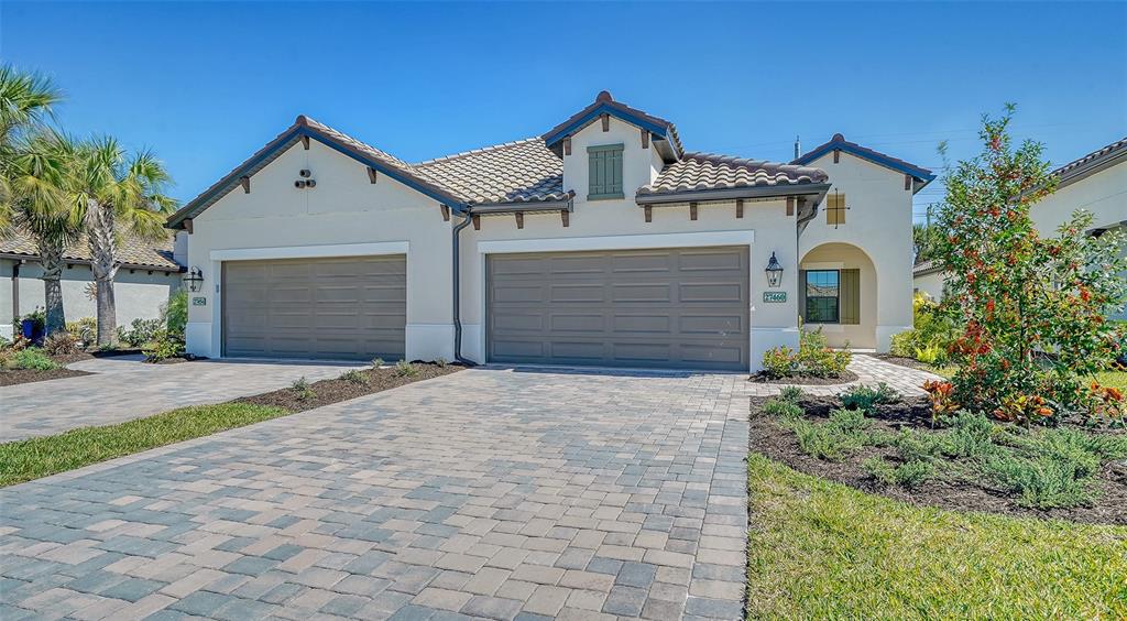 a front view of a house with a yard and garage