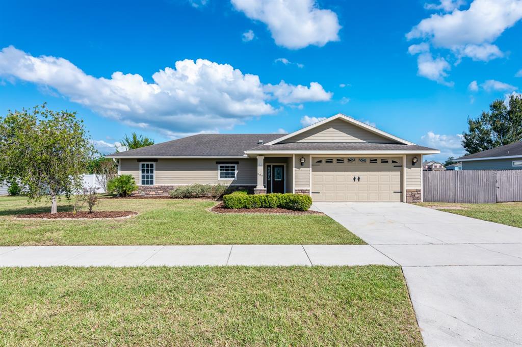 a front view of a house with a yard and garage