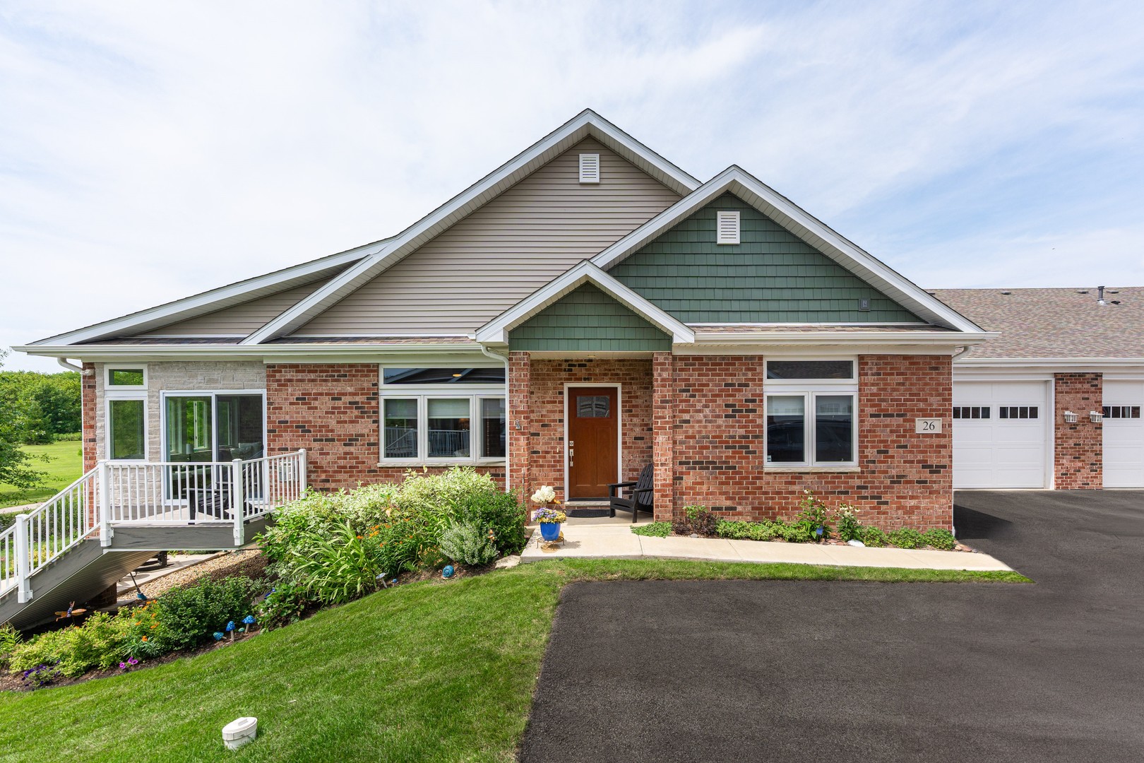 a front view of house with yard and green space