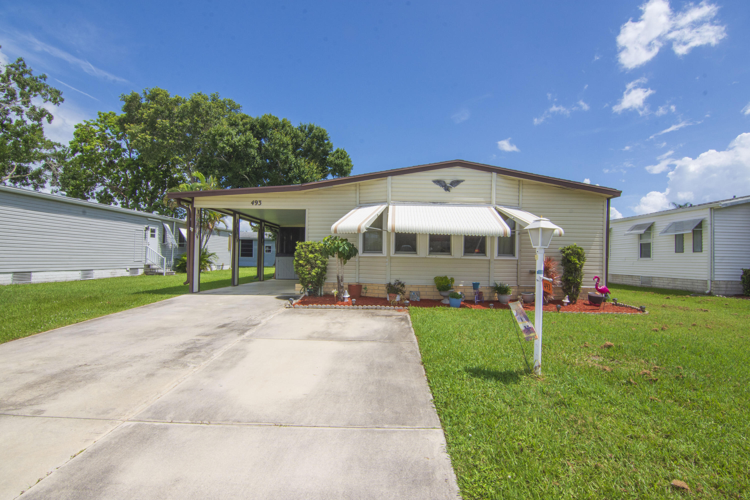 a front view of a house with a yard and porch