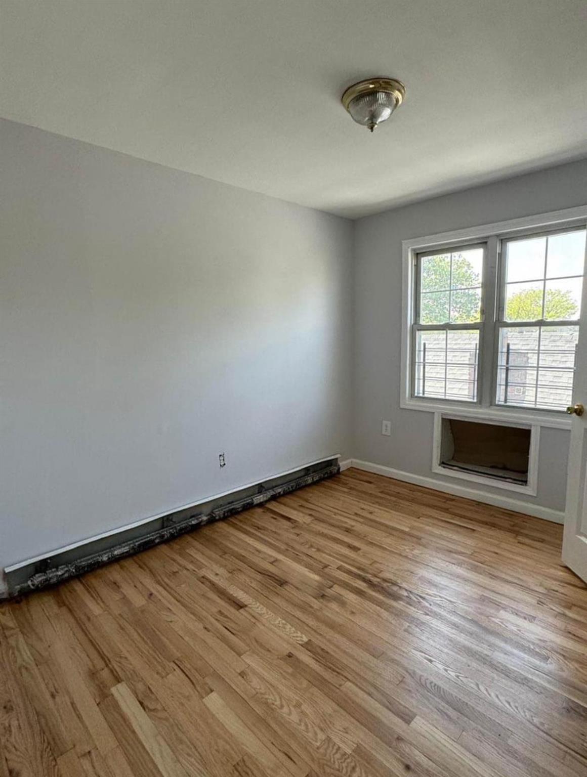 Spare room featuring light wood-type flooring