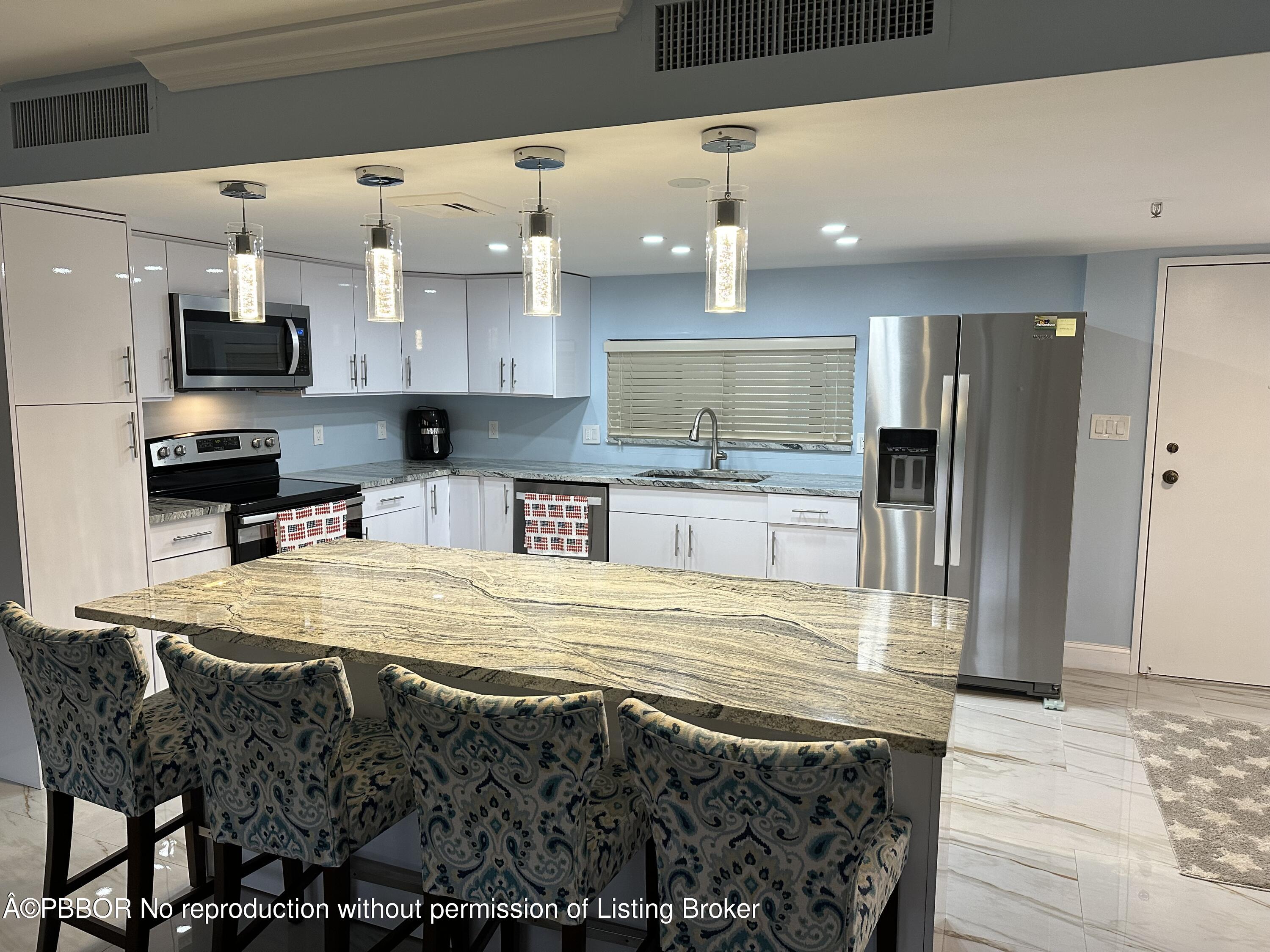 a large kitchen with stainless steel appliances kitchen island granite countertop a sink and cabinets