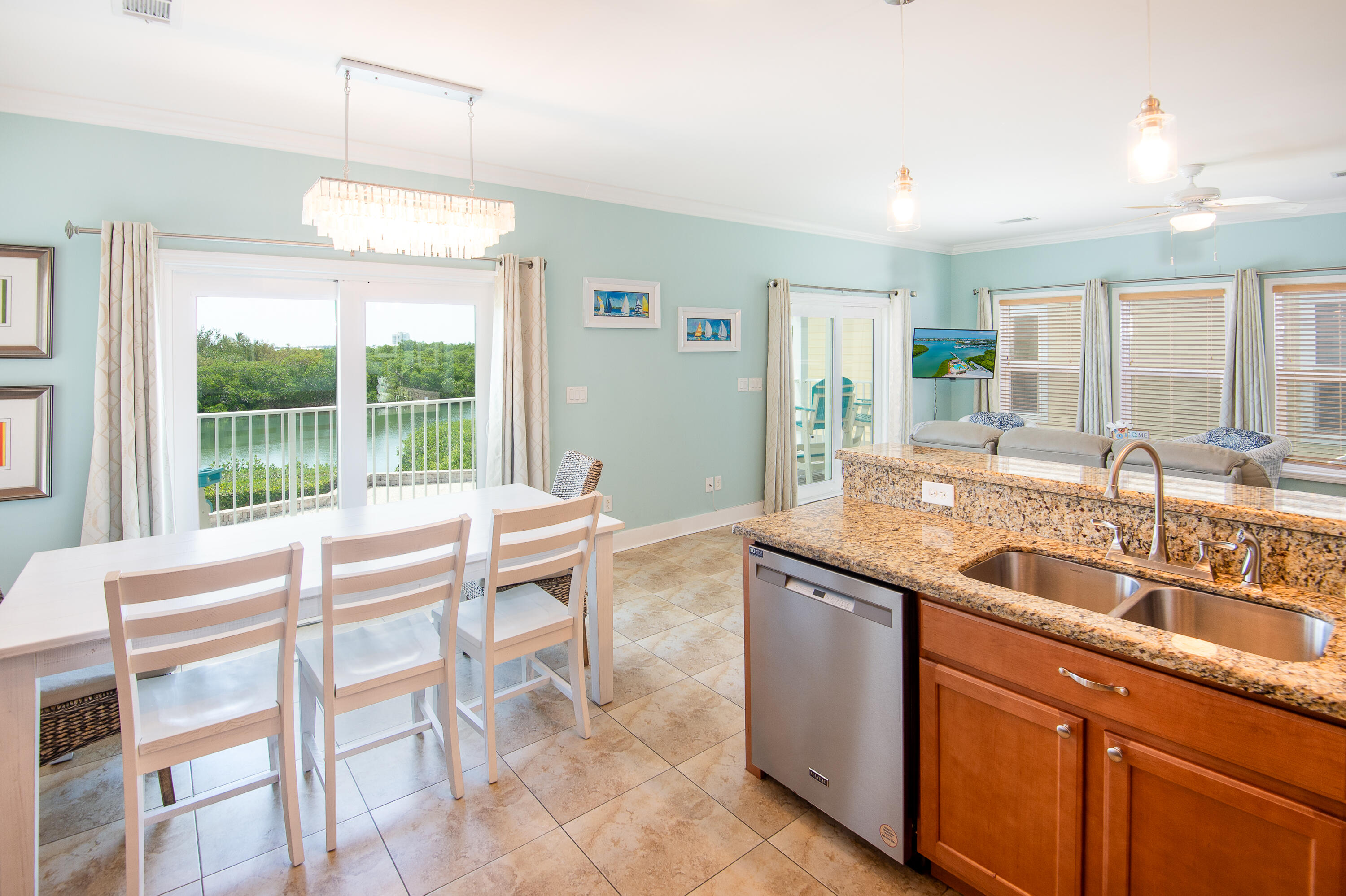 a kitchen with a sink and chairs