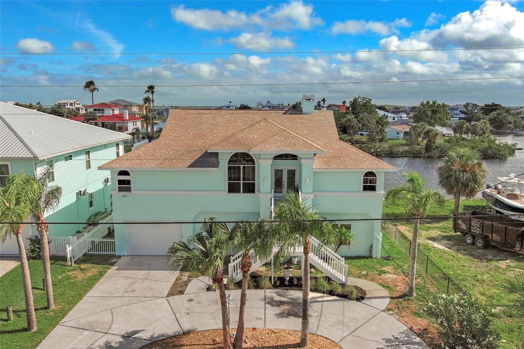 an aerial view of a house with a yard