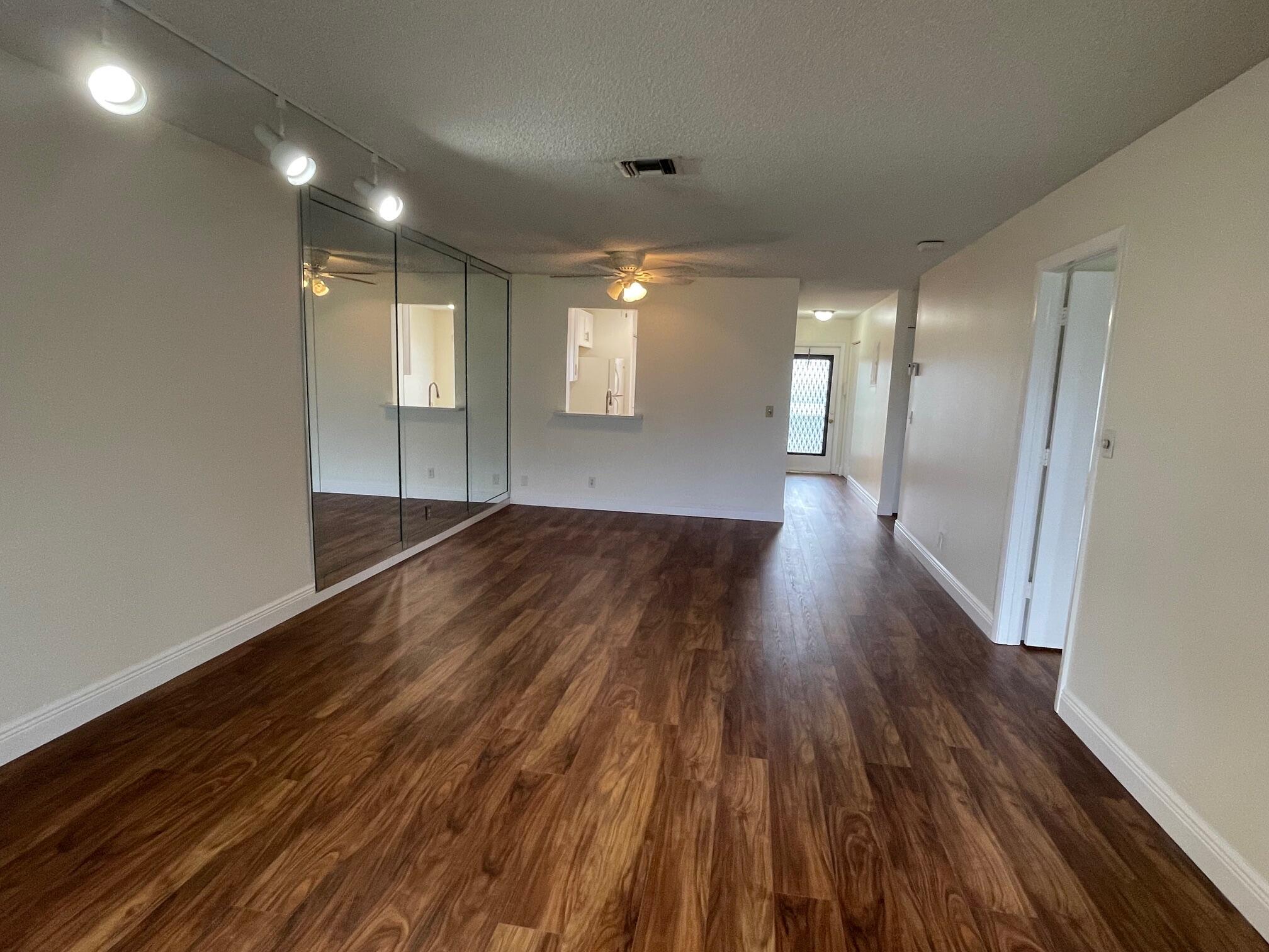 a view of a room with wooden floor