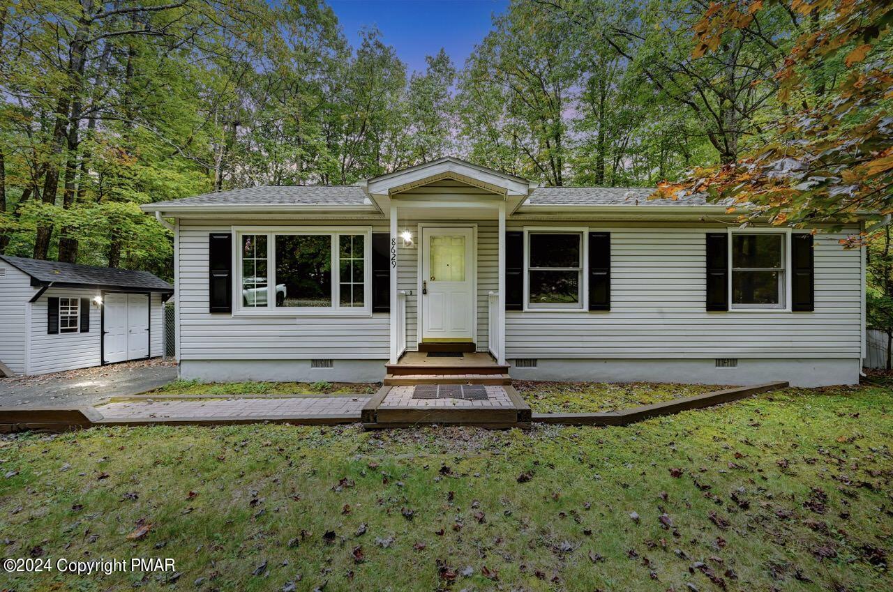 a front view of a house with a yard