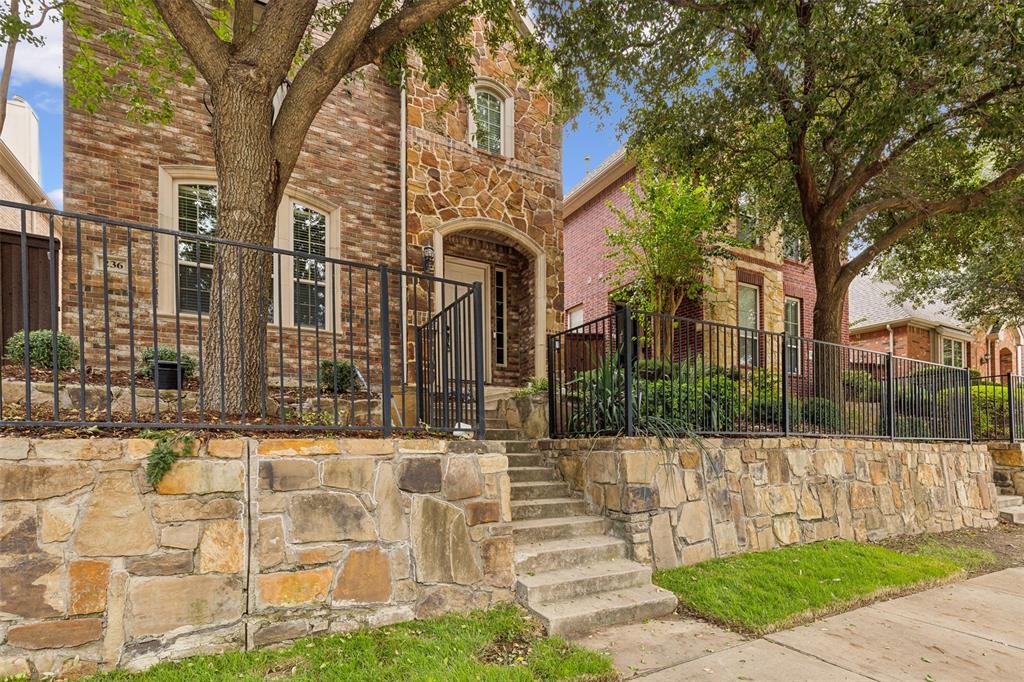 a view of a brick building next to a yard