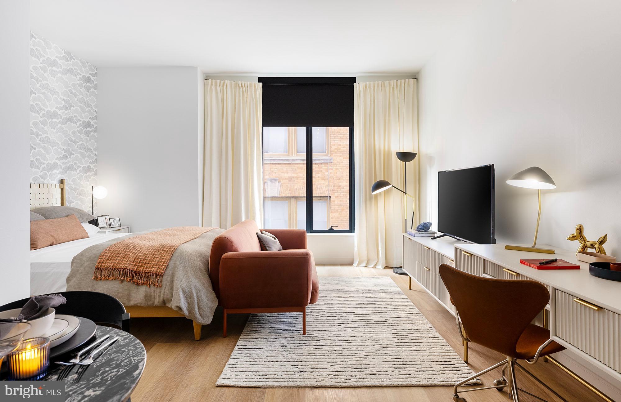 a bedroom with furniture bed and a flat screen tv