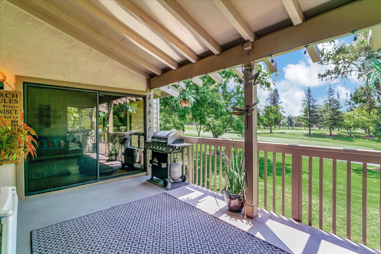 a view of a porch with furniture and garden