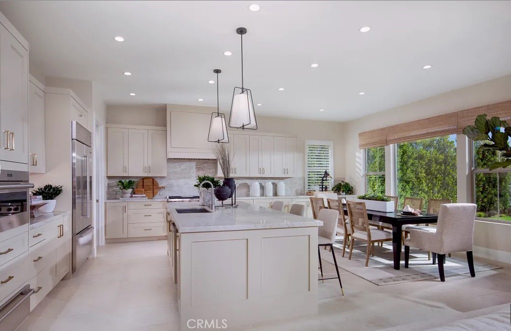 a kitchen with sink a counter and chairs