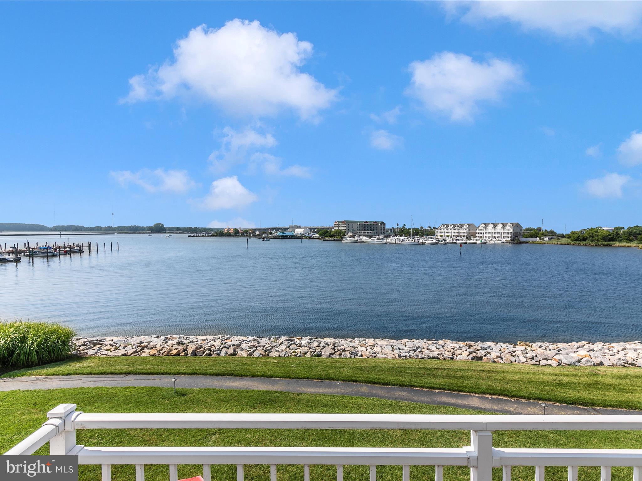 a view of a lake with houses in the background