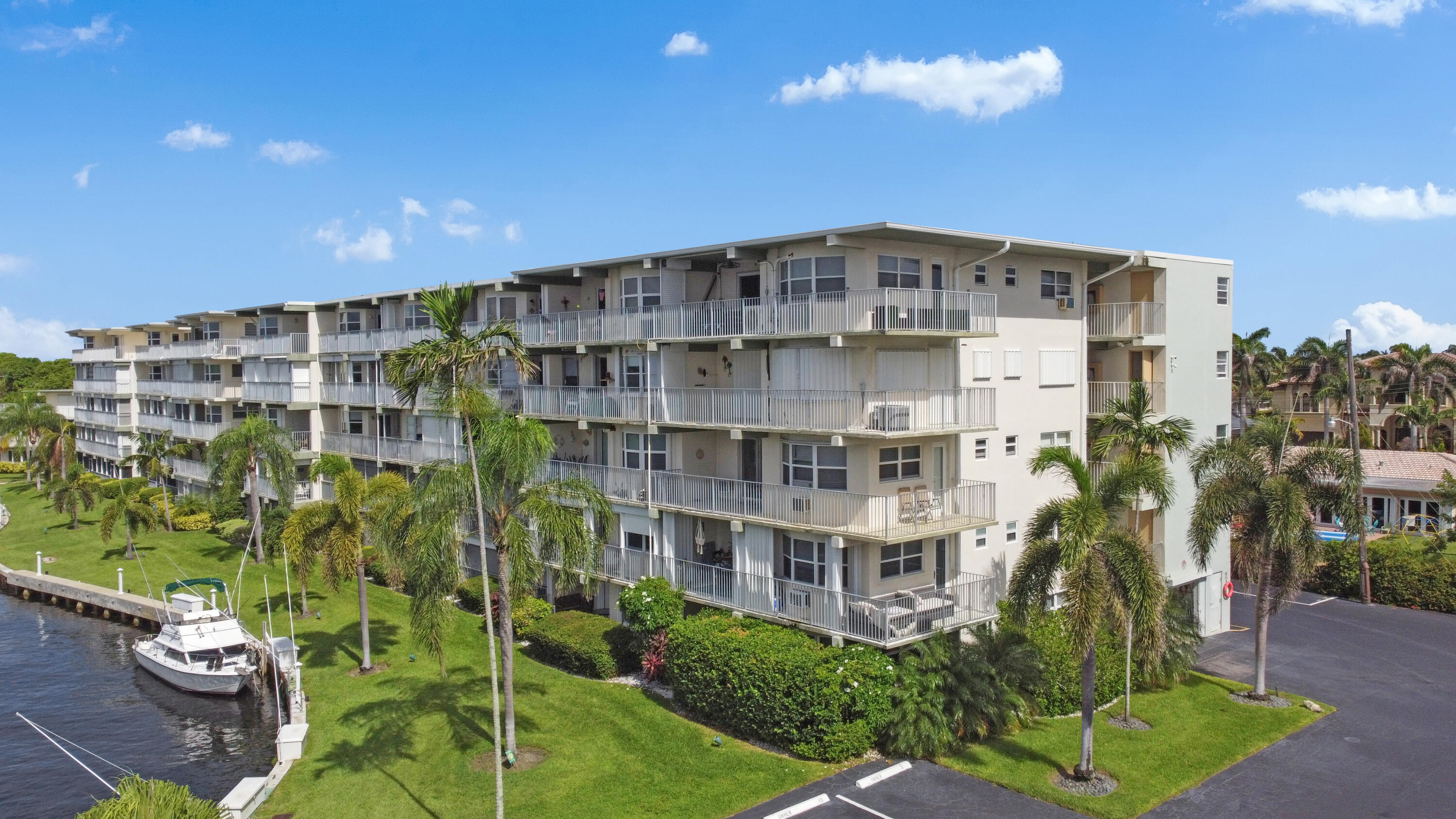 a front view of a multi story residential apartment building with a yard