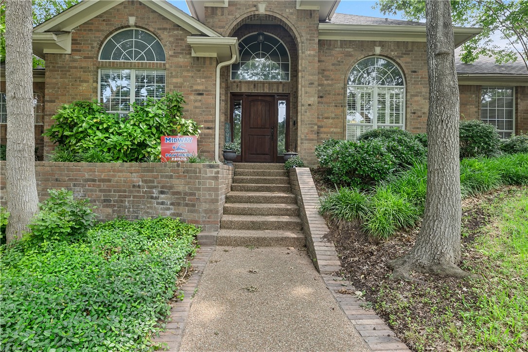 a front view of a house with garden