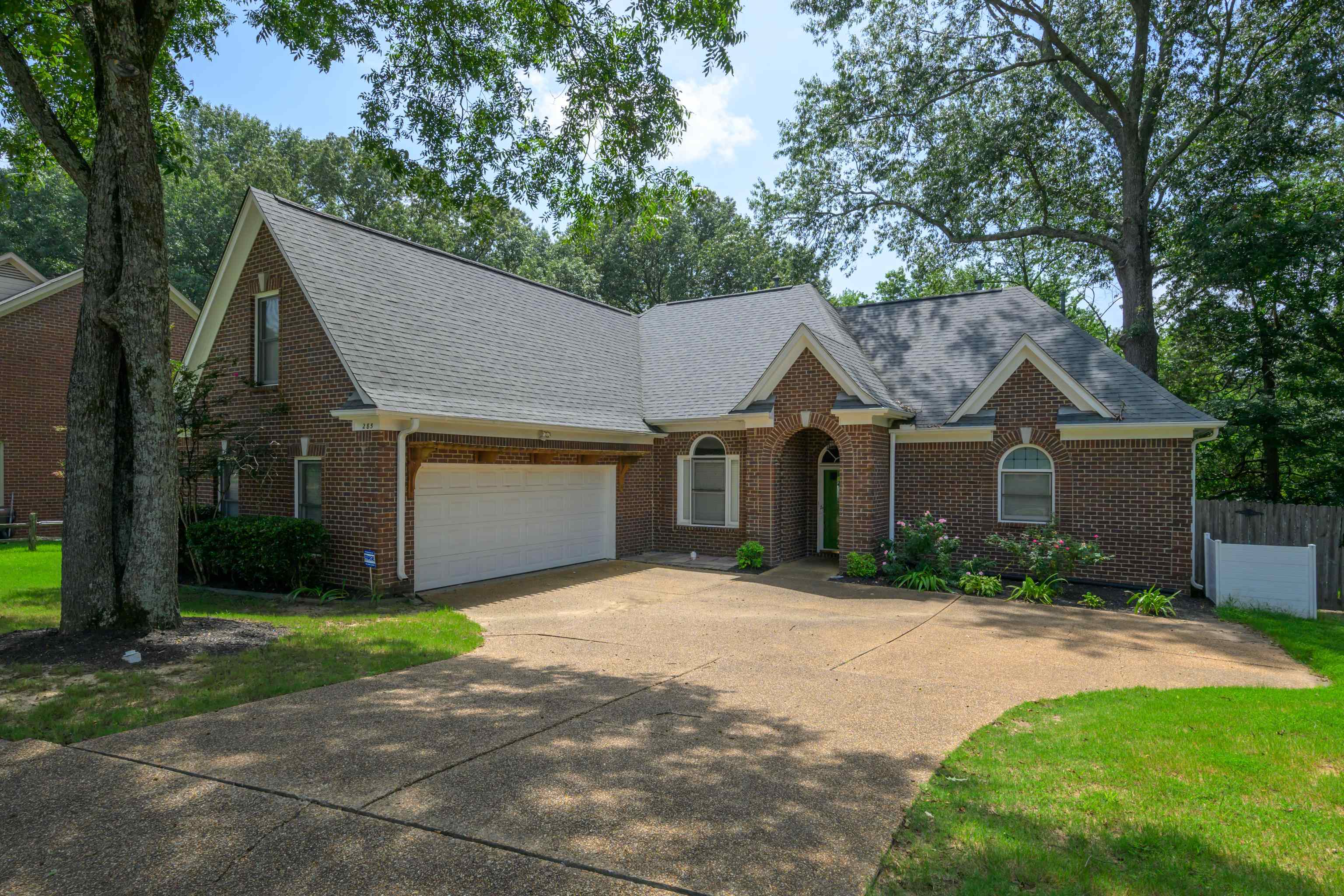 a front view of house with yard and trees