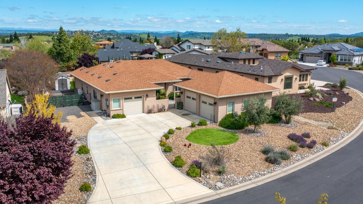 an aerial view of a house with a yard and lake view