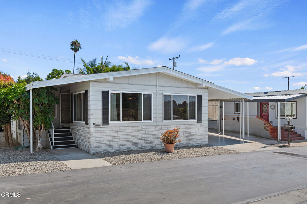 a front view of house with yard outdoor seating and barbeque oven