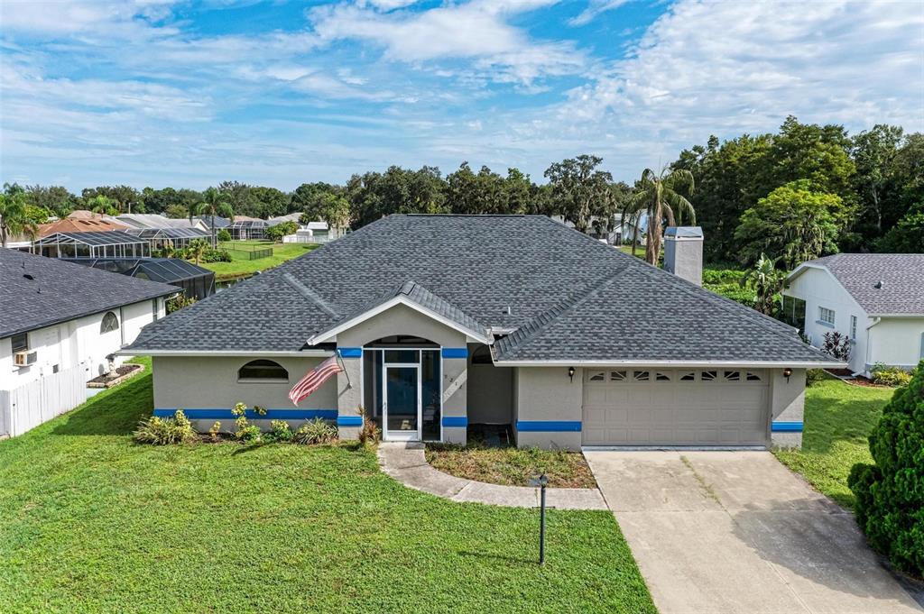 a aerial view of a house with table and chairs under an umbrella