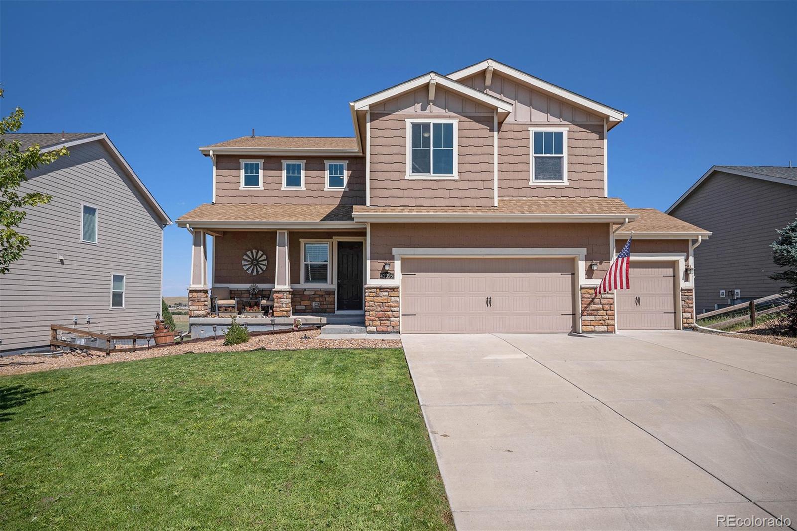 a front view of a house with patio and yard