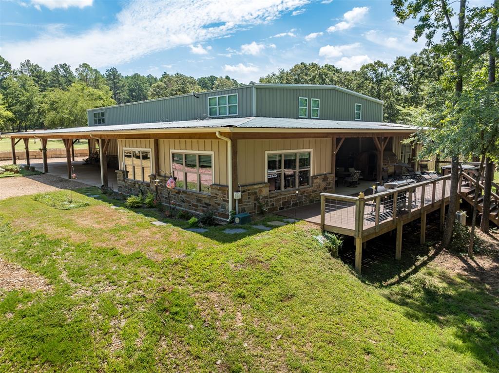 a view of a house with pool and a yard