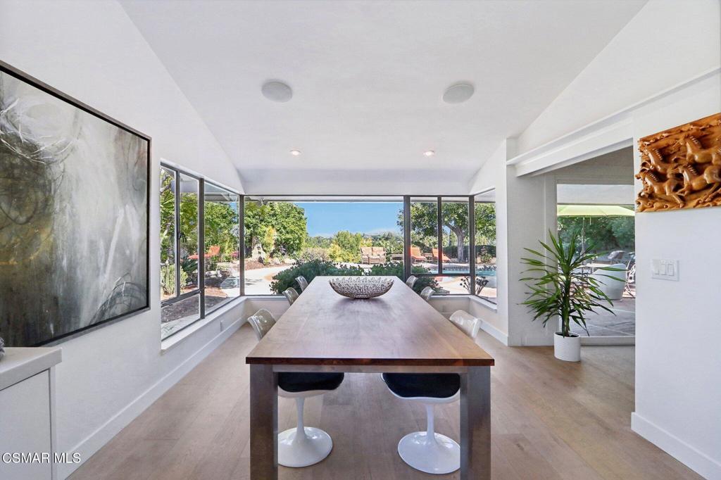 a view of a dining room with furniture window and wooden floor