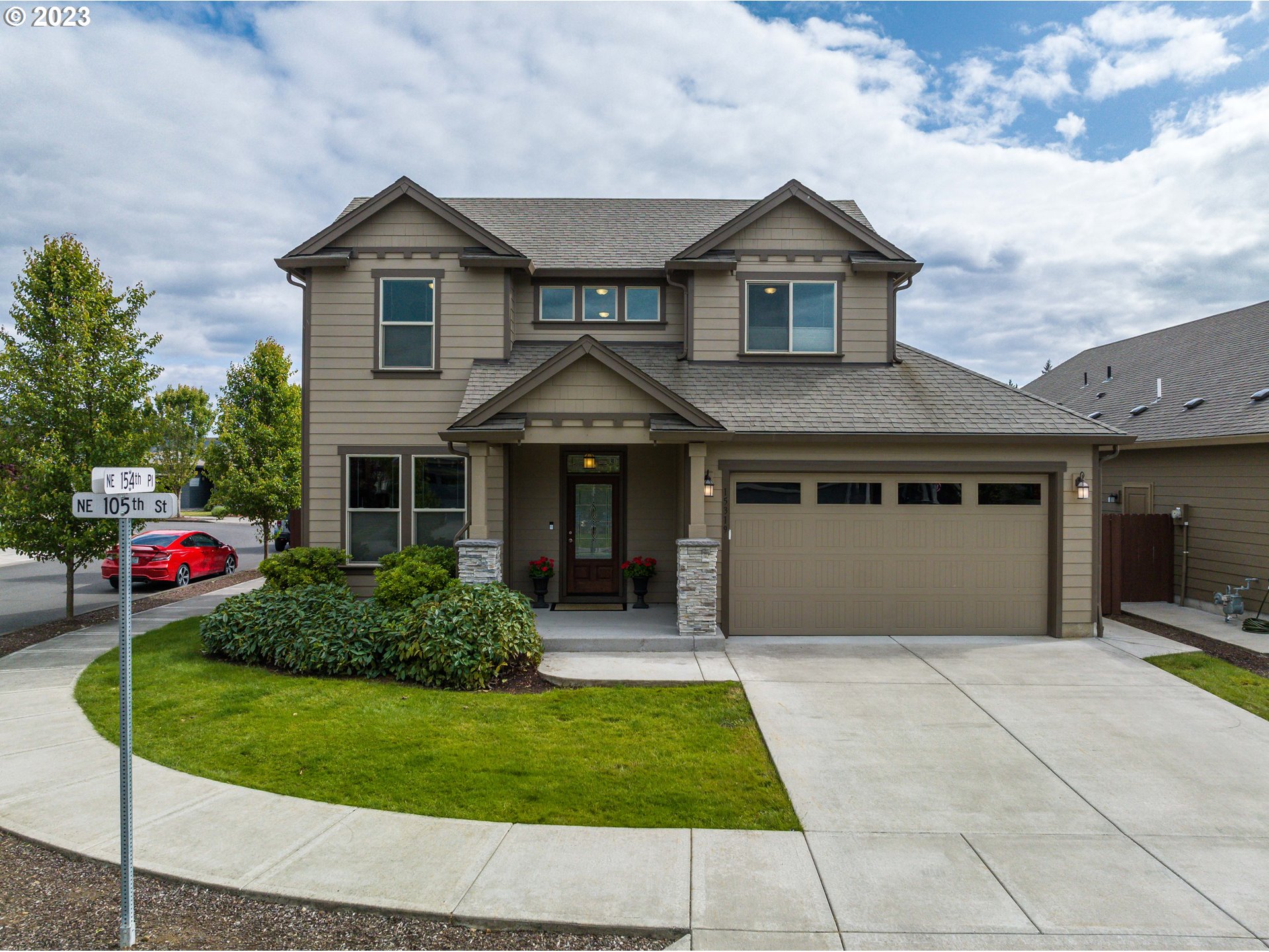 a front view of a house with a yard and garage