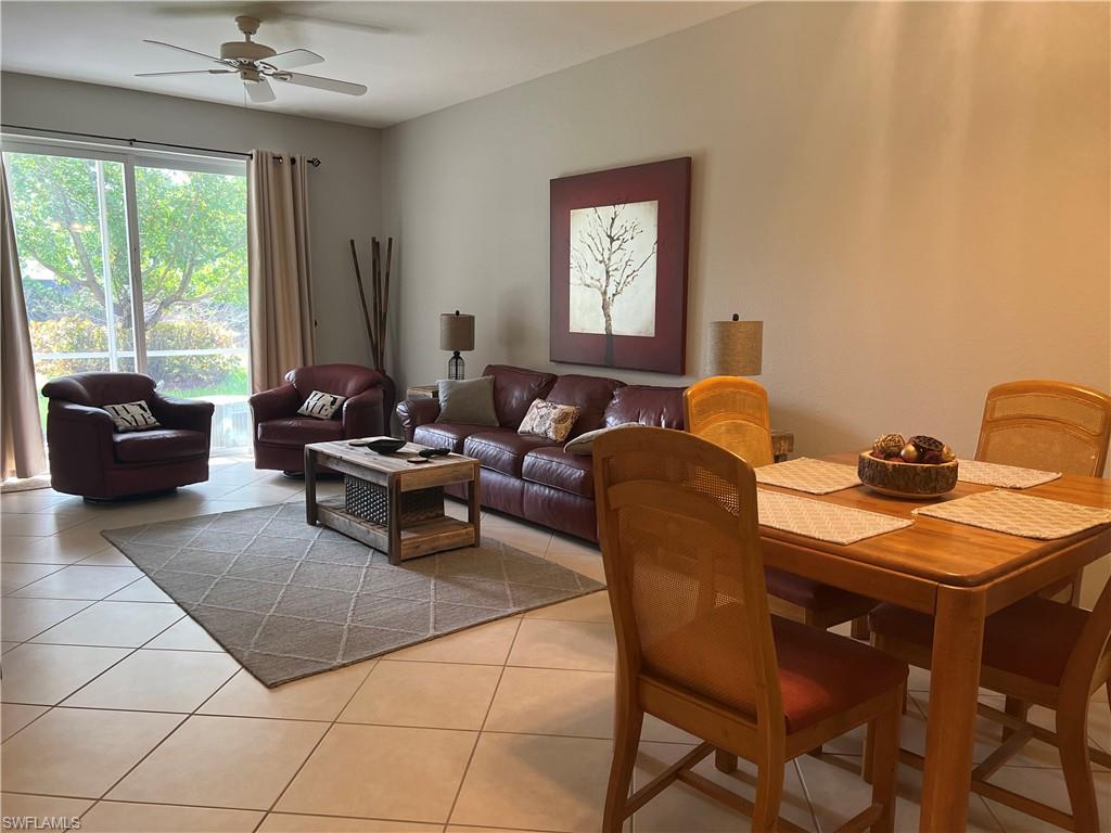 Dining area with ceiling fan and light tile floors