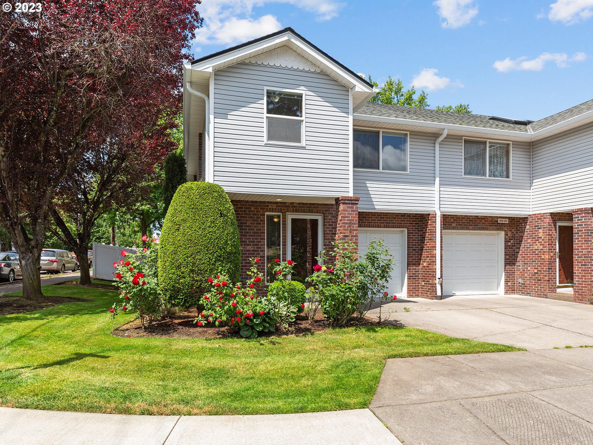 a front view of house with yard and green space