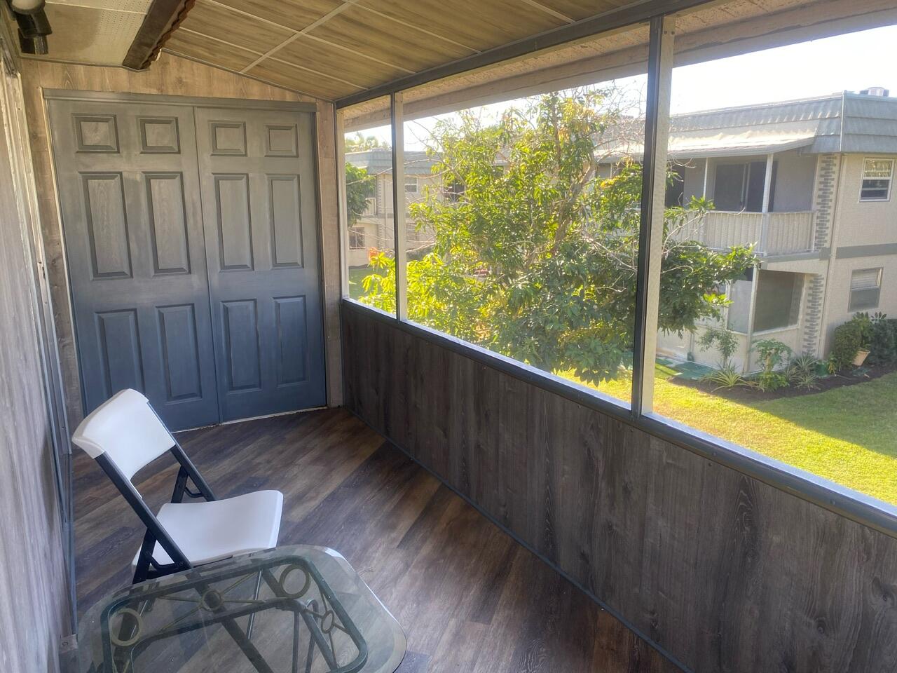 a view of a room with furniture and wooden floor