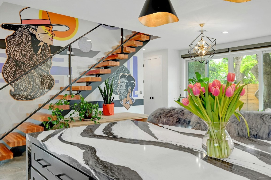 a dining room filled with furniture and a potted plant