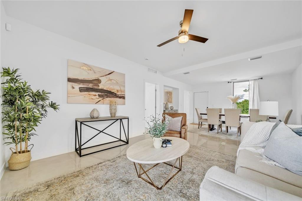 Living room with tile patterned flooring and ceiling fan