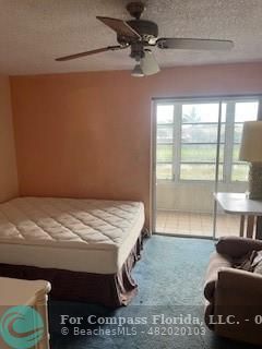 a bedroom with a bed and glass window