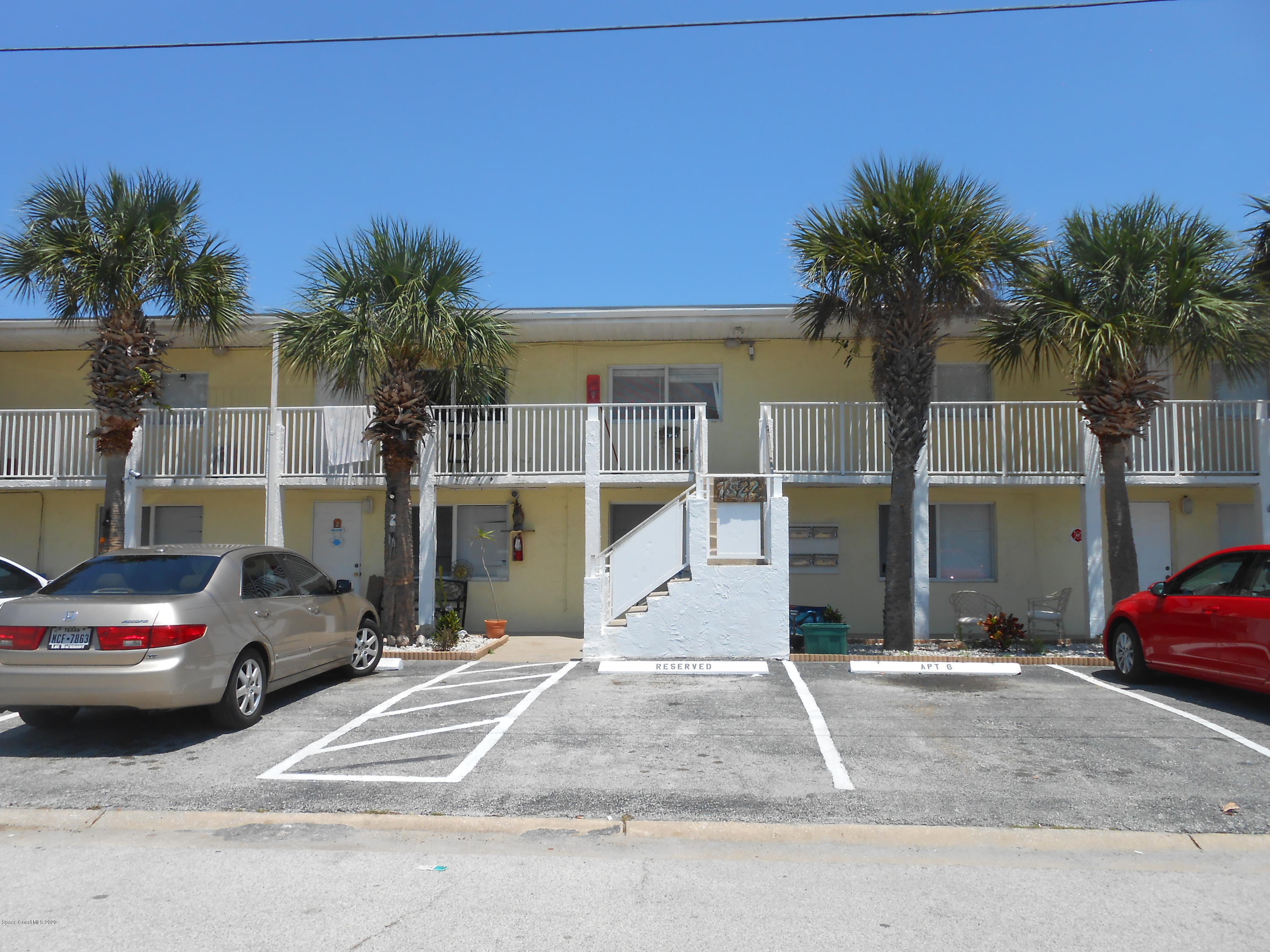 a view of building with car parked