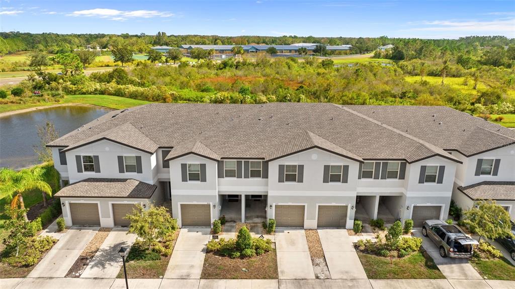 a aerial view of multiple houses with a lake