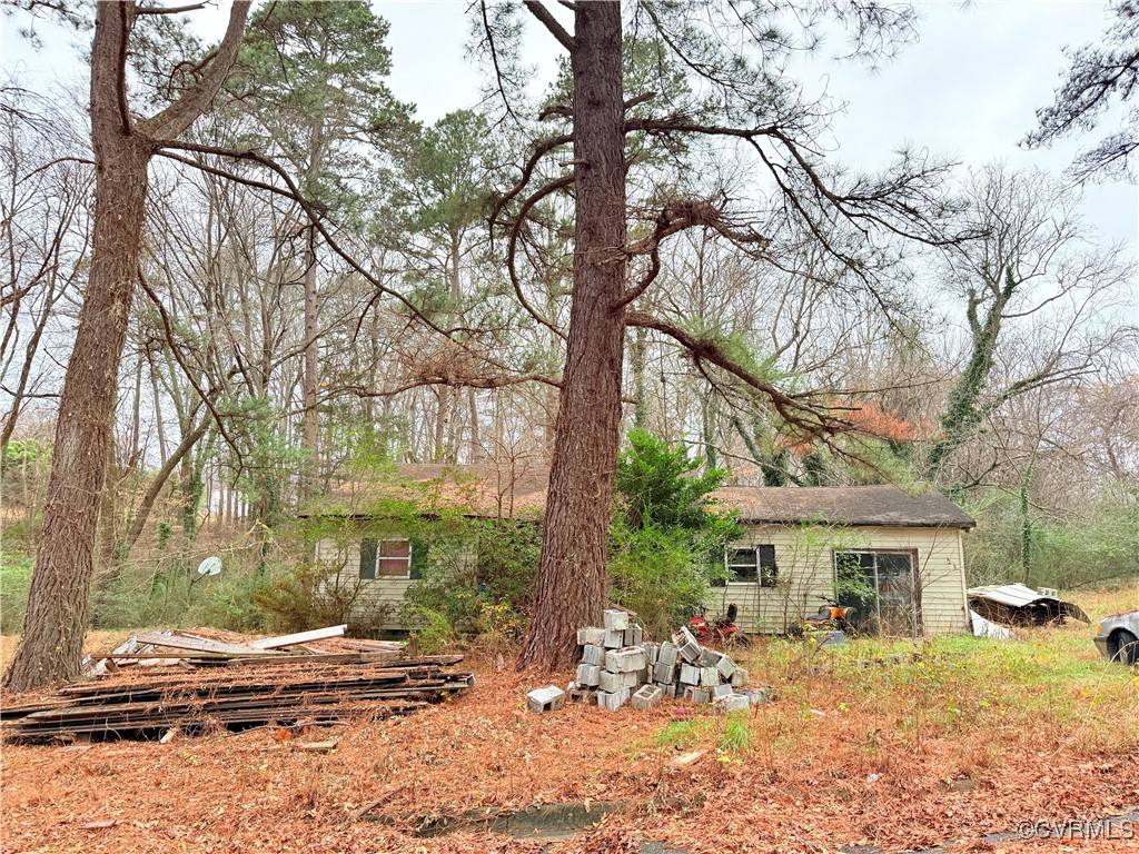 a view of a house with a yard covered in snow