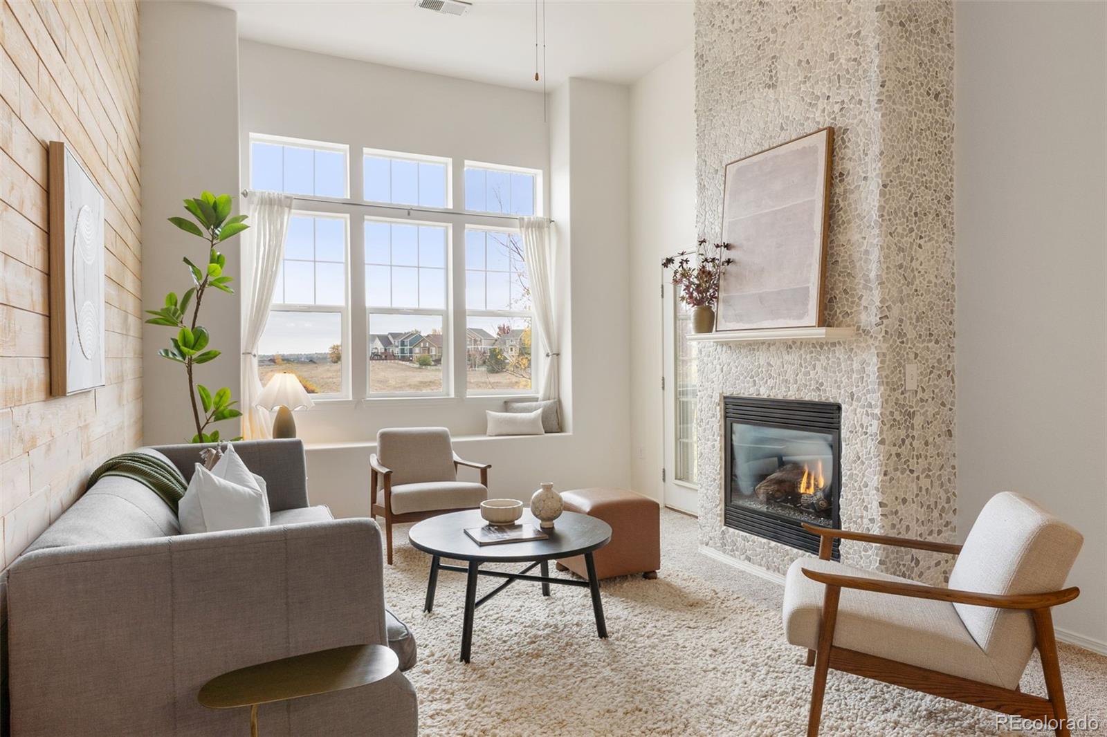 a living room with furniture fireplace and window