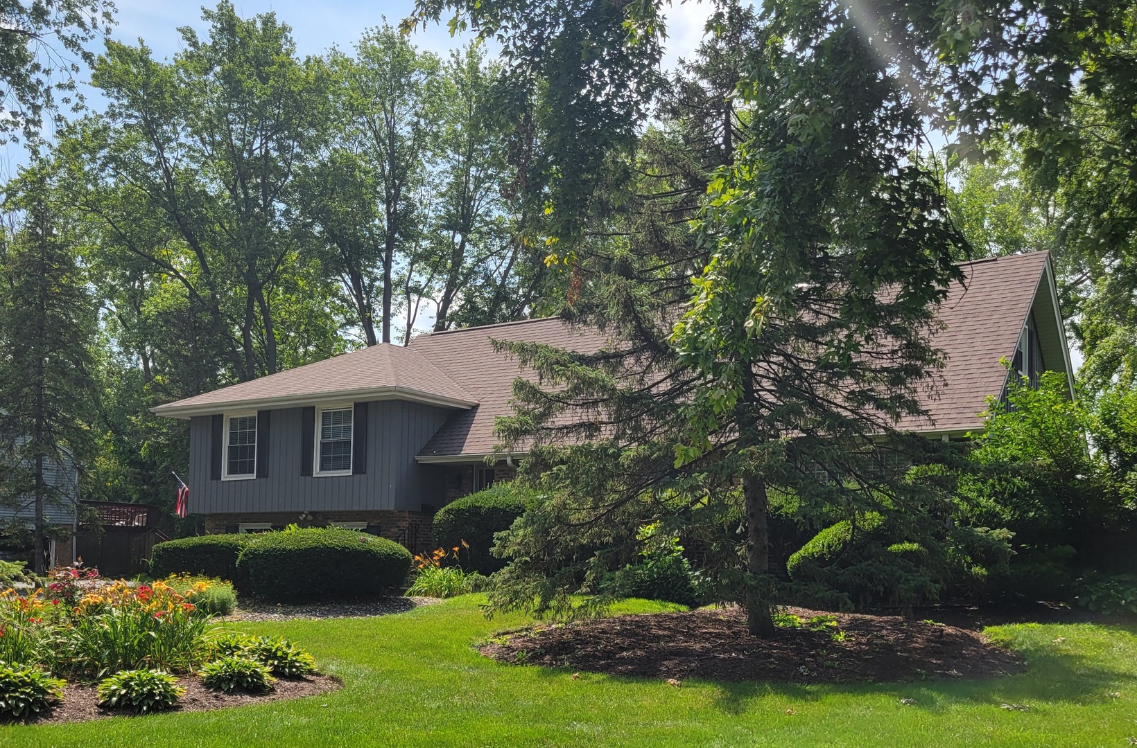 a front view of a house with a garden