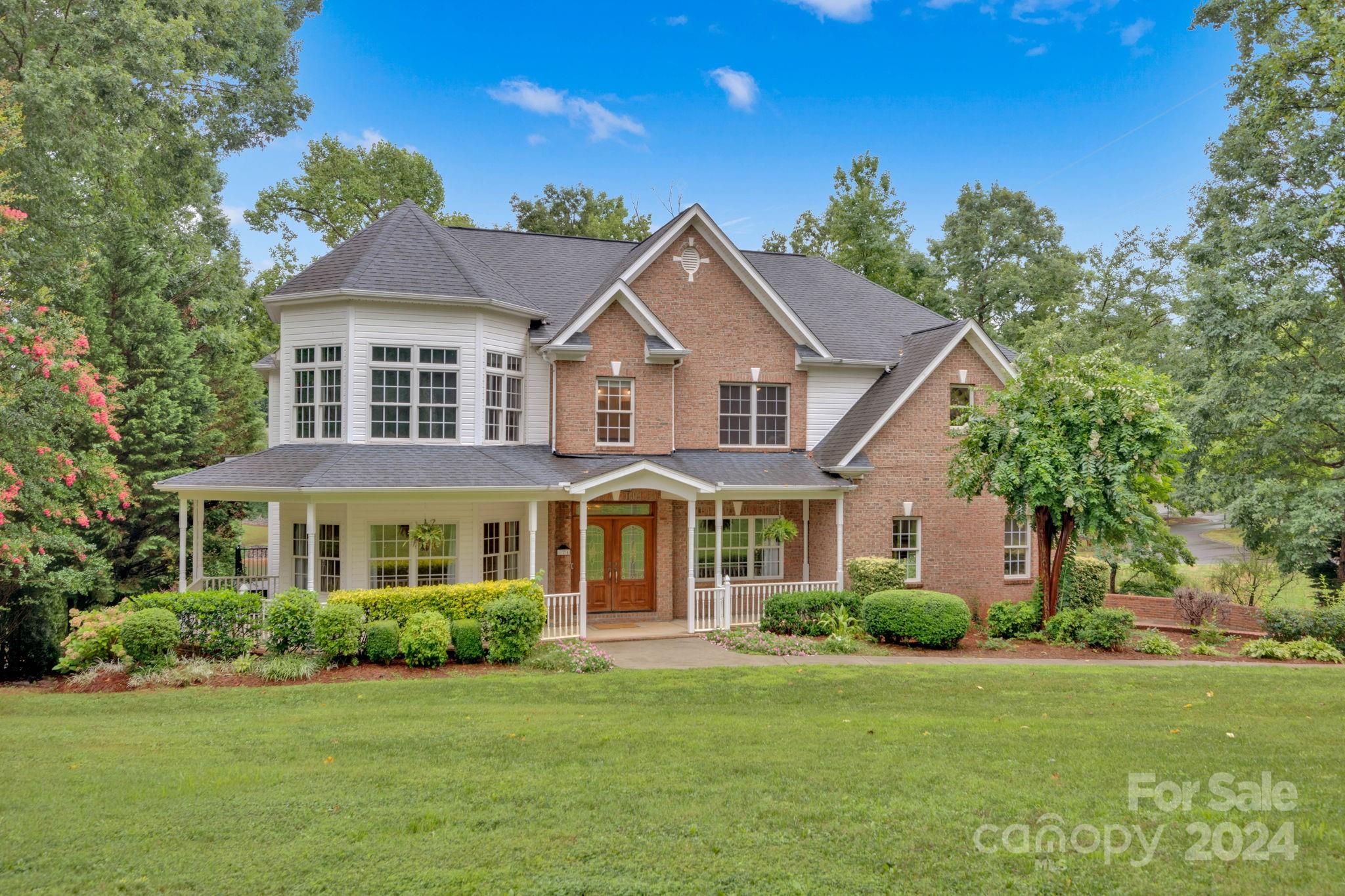 a front view of a house with a garden