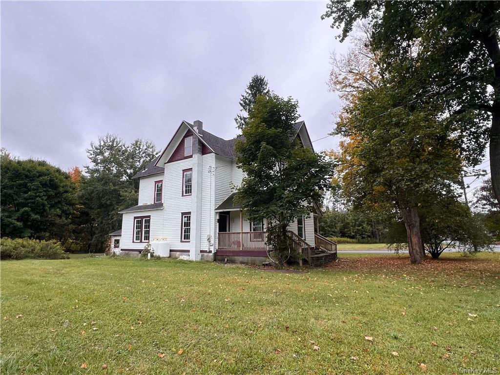 a view of house with outdoor space and garden