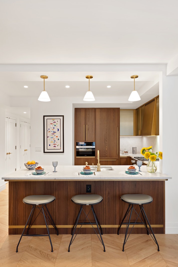 a kitchen with a dining table and chairs