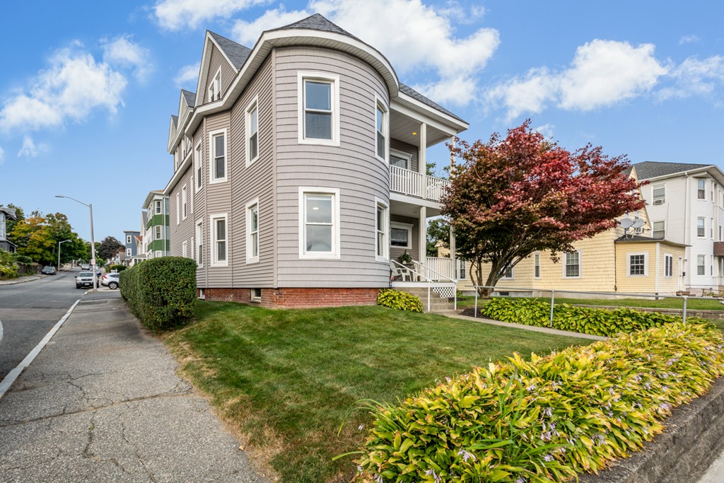 a front view of a house with a garden