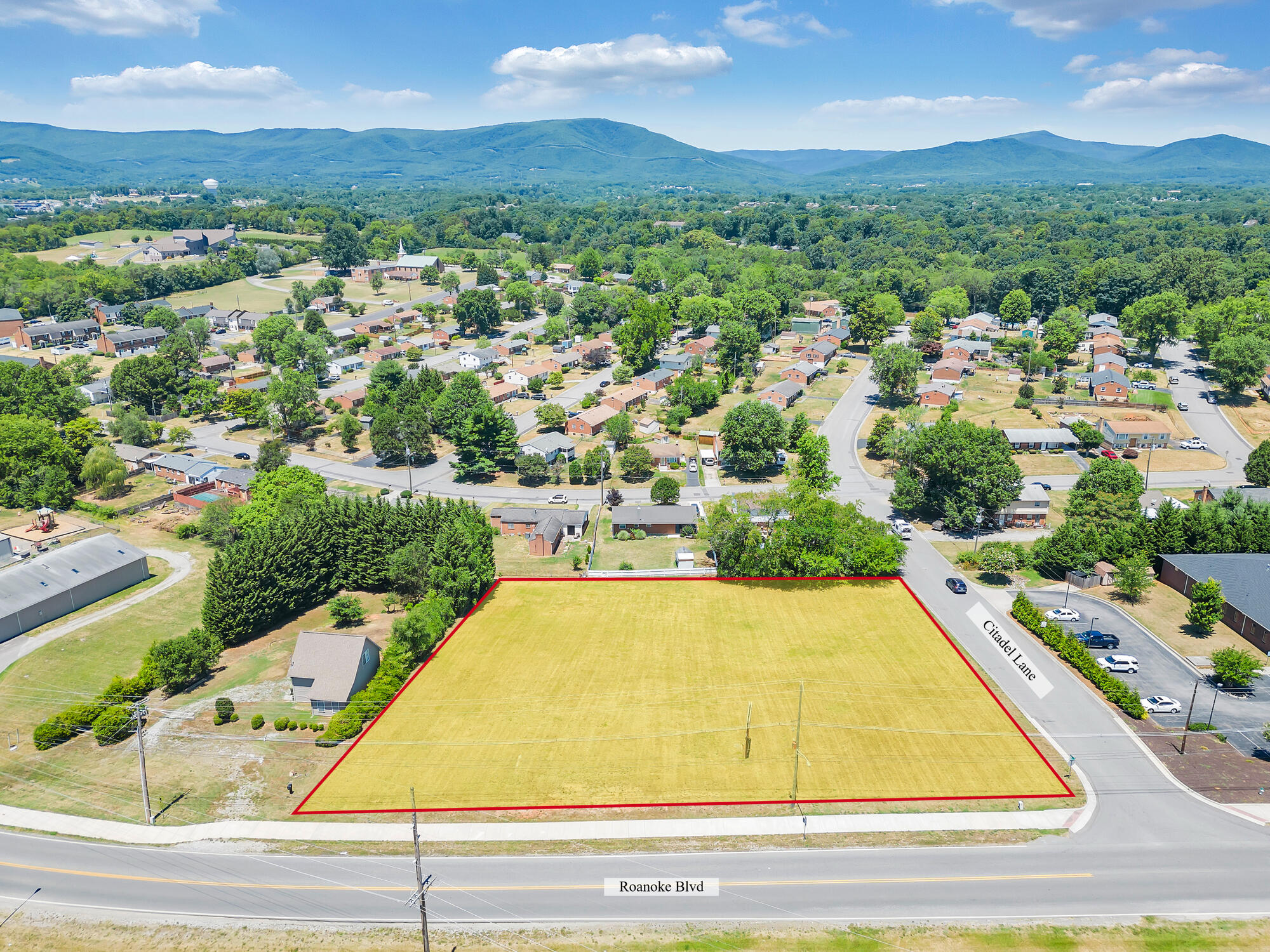 an aerial view of residential houses with outdoor space and river