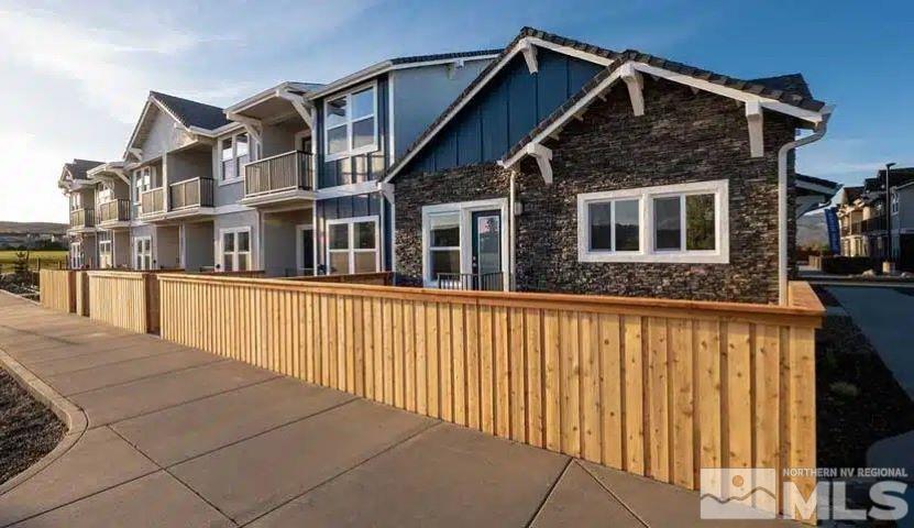 a view of a house with wooden fence