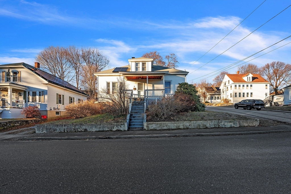 a front view of a house with a garden