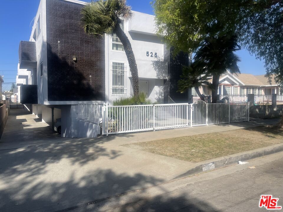 a view of a house with a small yard and floor to ceiling window