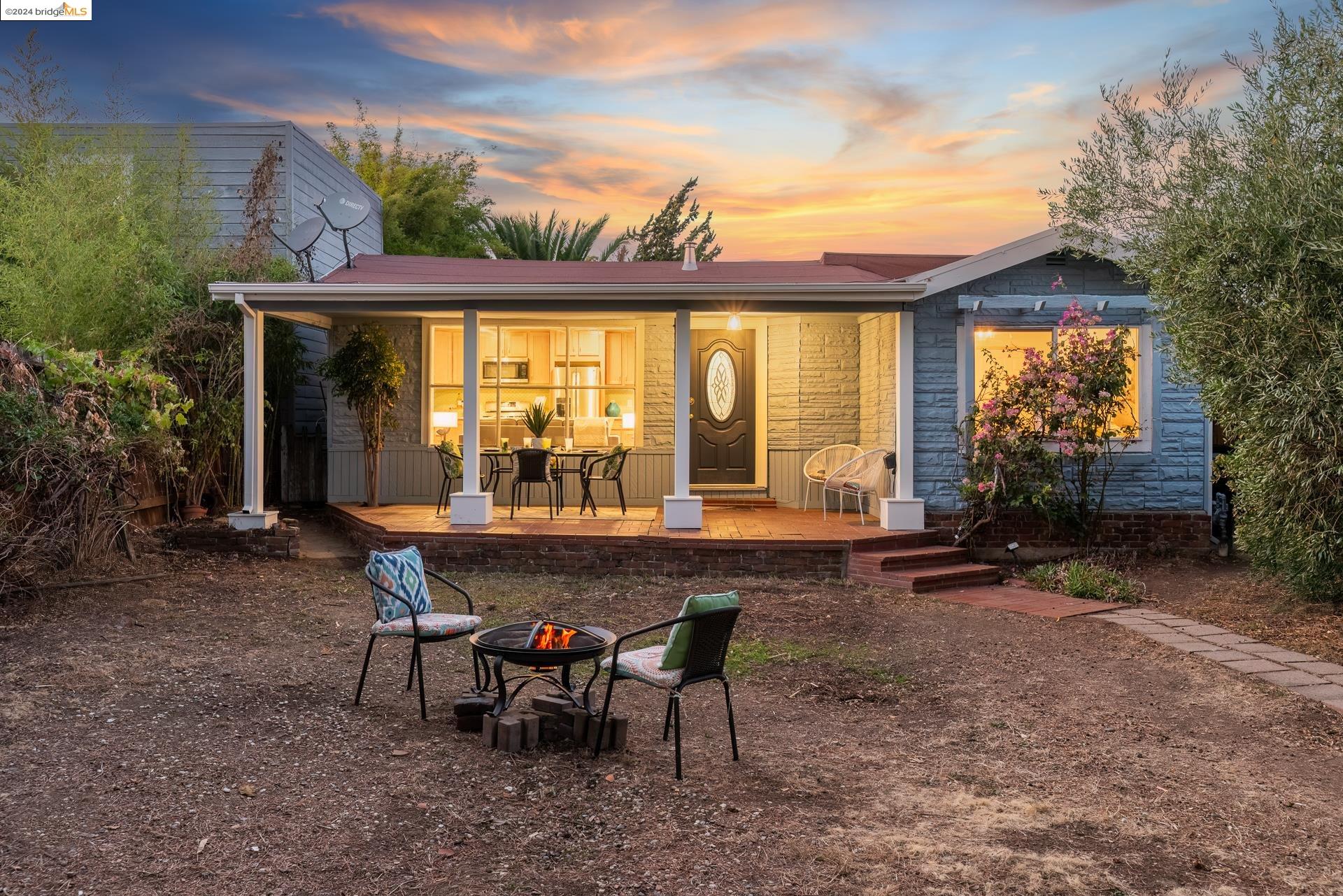 a view of a house with backyard and sitting area